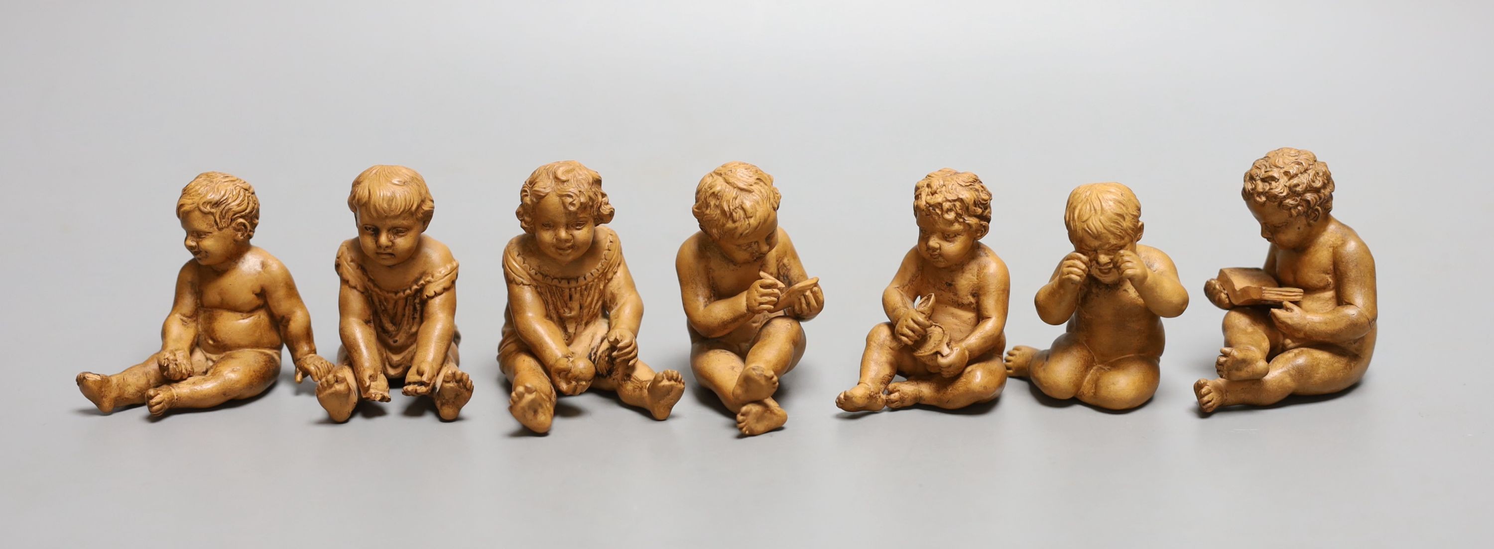 A group of seven terracotta figures of playful youths